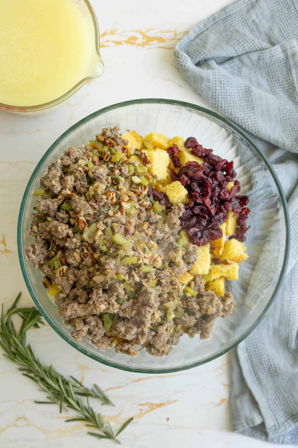 Meat and cornbread stuffing in a glass bowl.