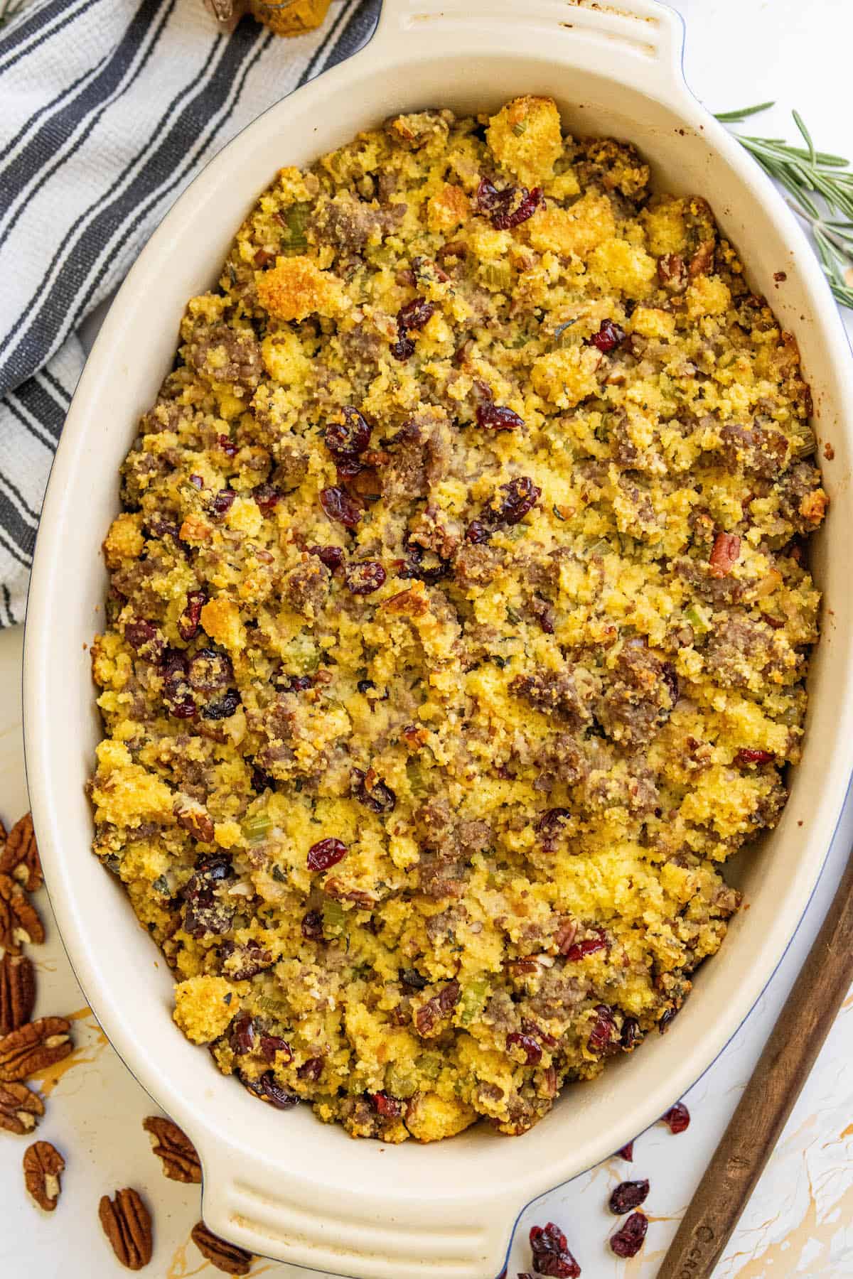Cranberry sausage stuffing in a white dish with cornbread.