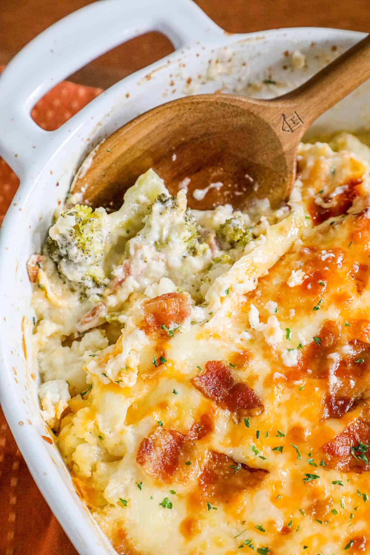 A broccoli casserole dish with cheese and bacon.