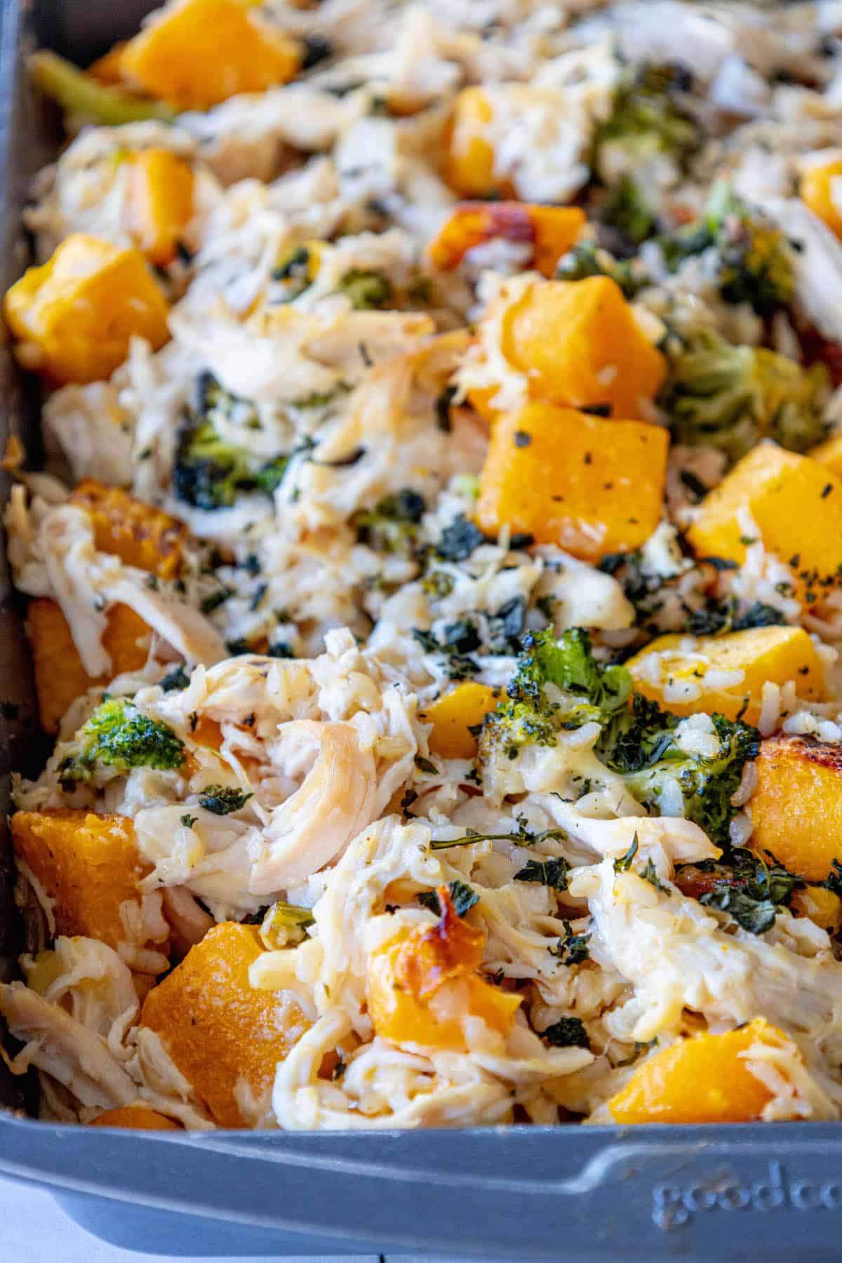A casserole dish filled with chicken, broccoli and Butternut squash.