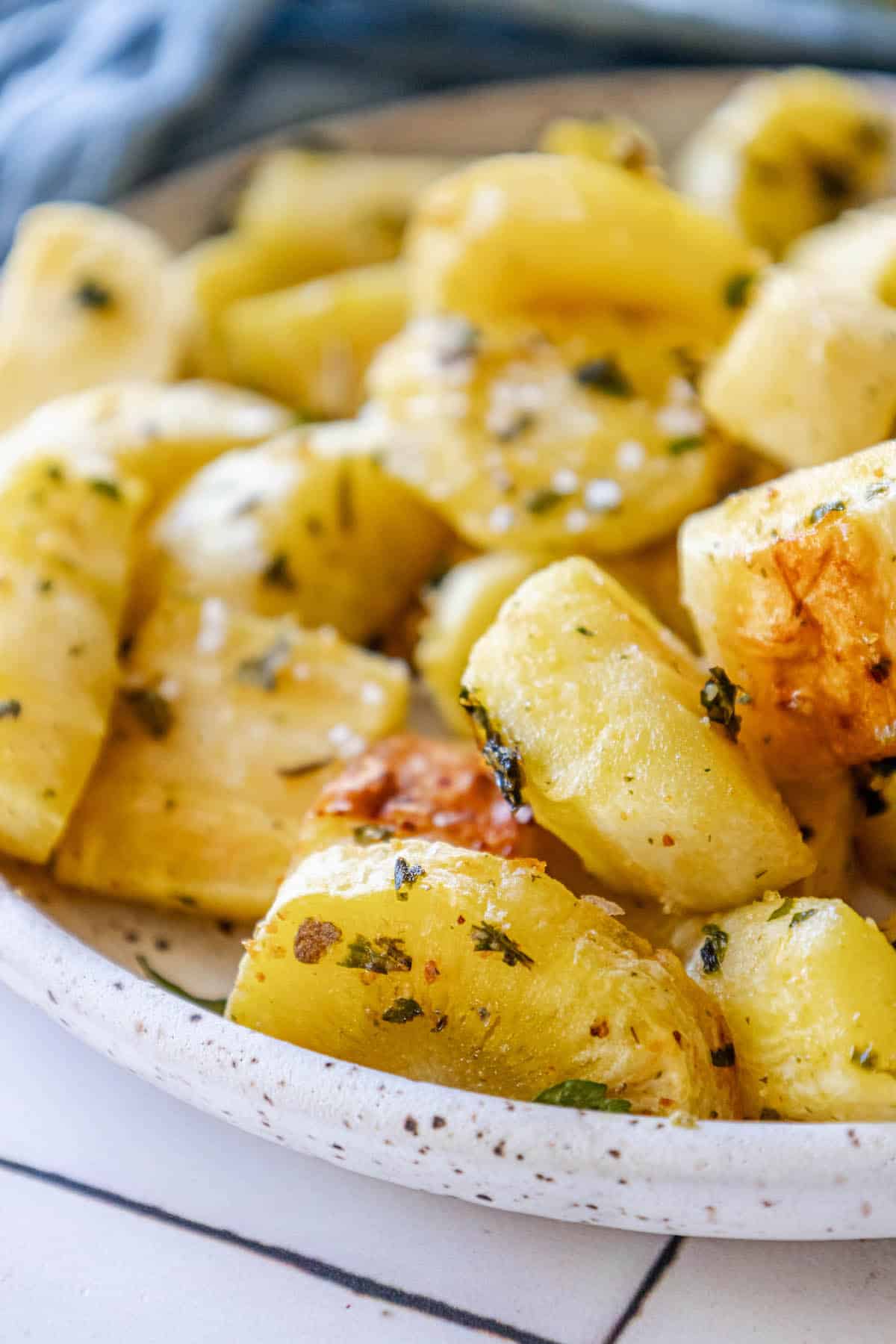 Herbed roasted potatoes on a plate.