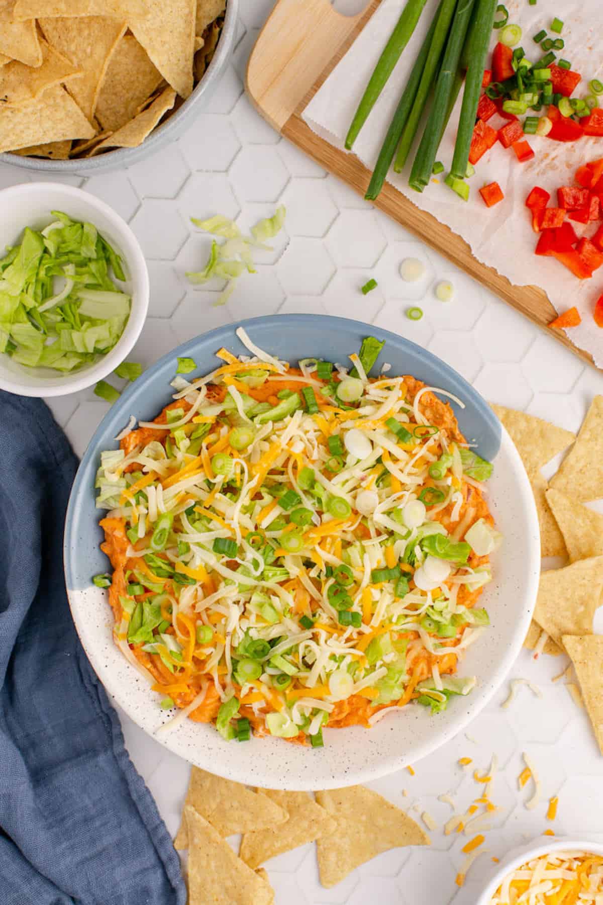 A hot cheesy chicken dip with tortilla chips.