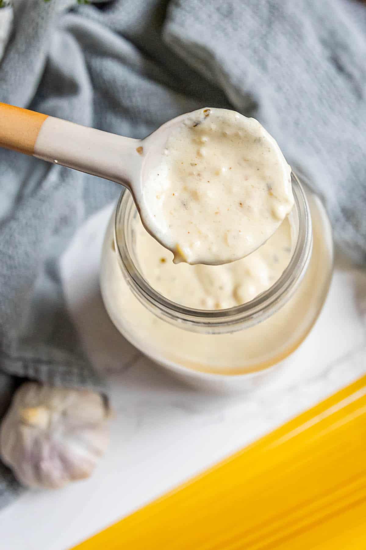 A jar of the best alfredo sauce, perfect for adding a spoonful to your favorite dishes.