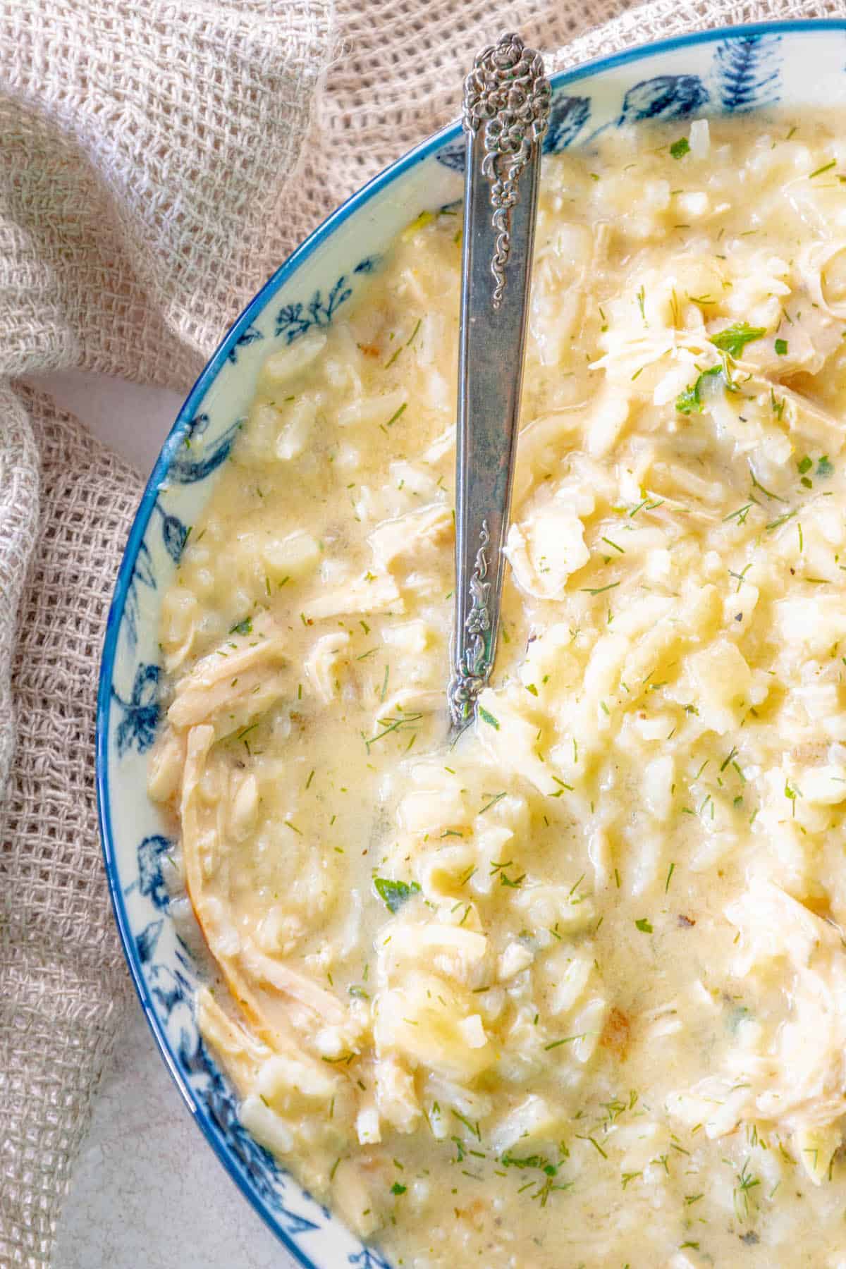 Greek chicken risotto in a bowl with a spoon.