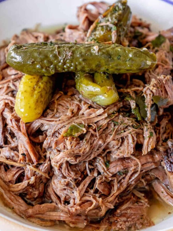 A bowl of pulled pork with pickles