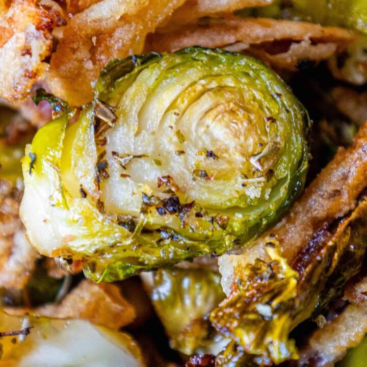 A close up of roasted Brussels sprouts and onions.