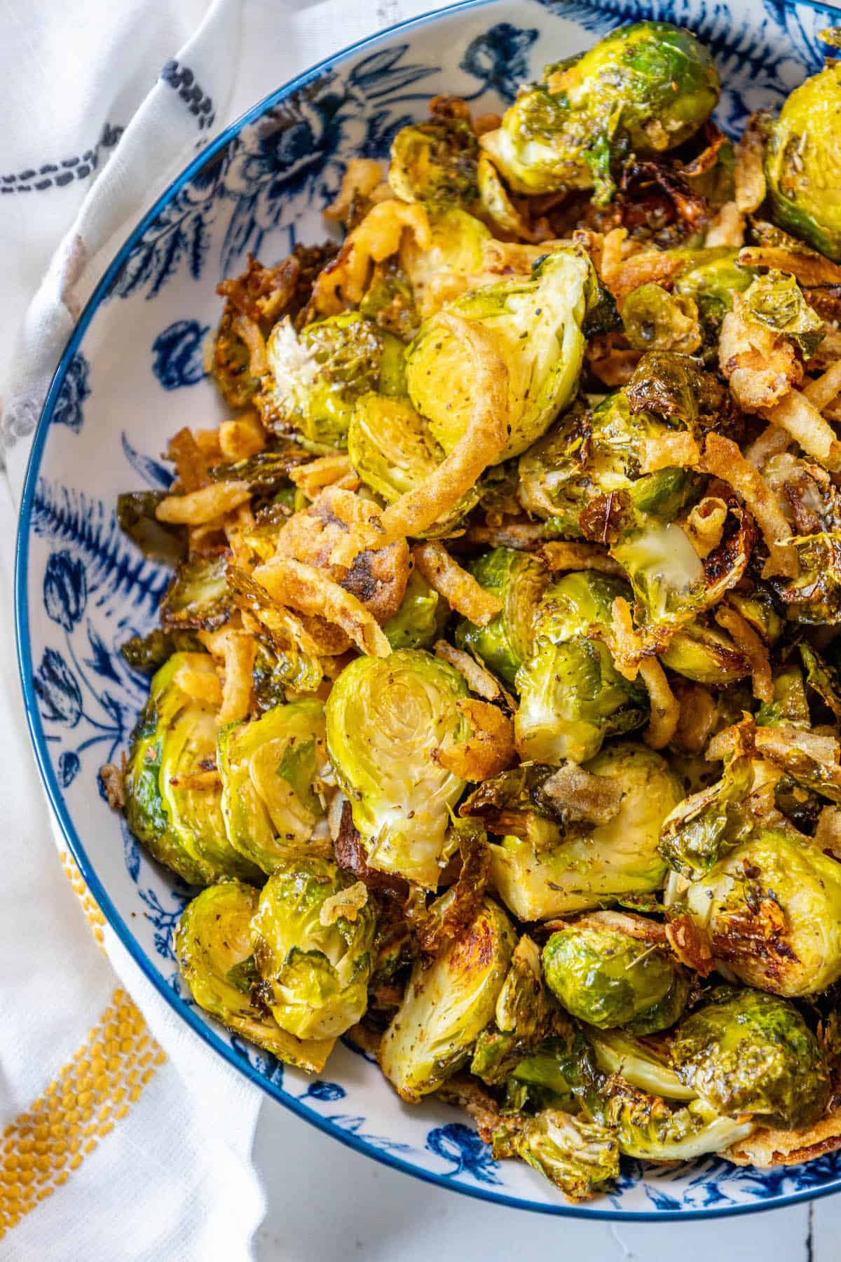 Roasted Brussels sprouts in a blue and white bowl.