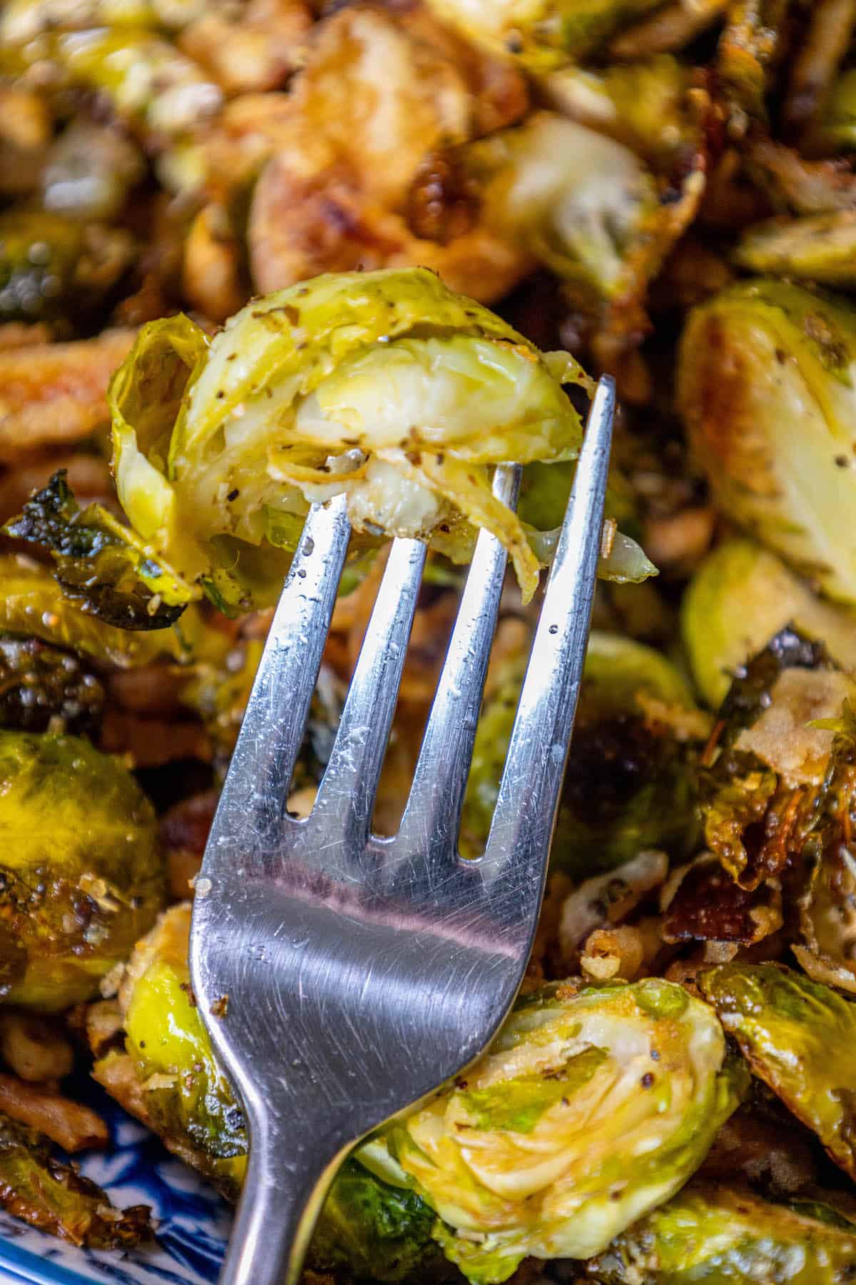 Roasted Brussels sprouts on a plate with a fork.