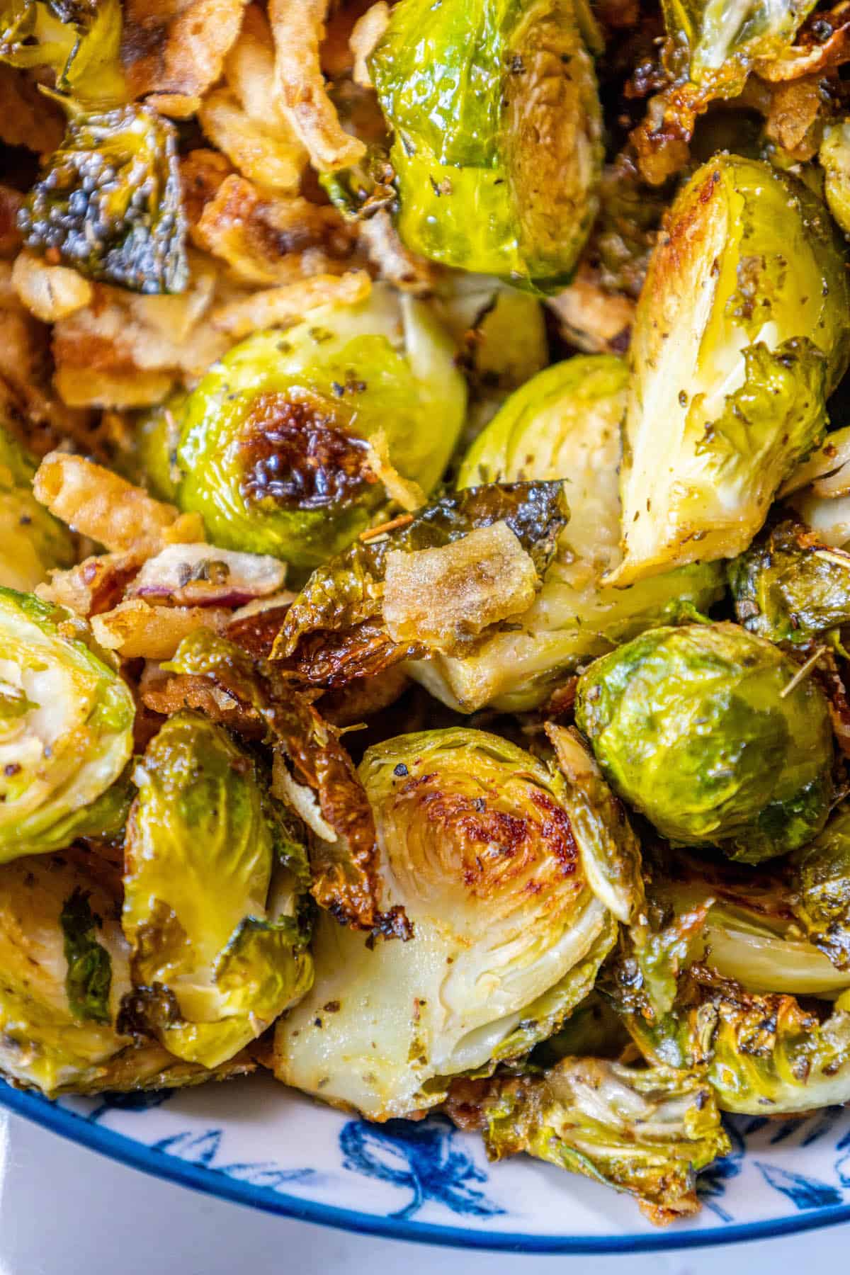 Roasted Brussels sprouts in a blue and white bowl.
