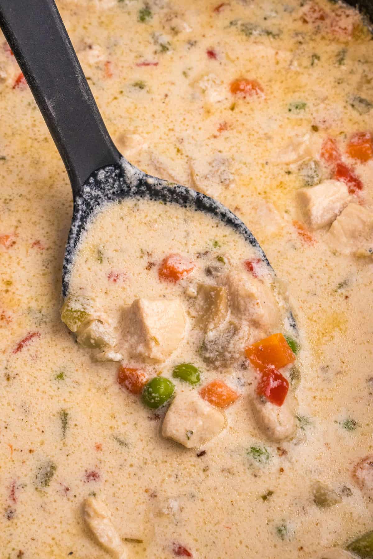 Slow Cooker Chicken Chowder in a skillet with a spoon.