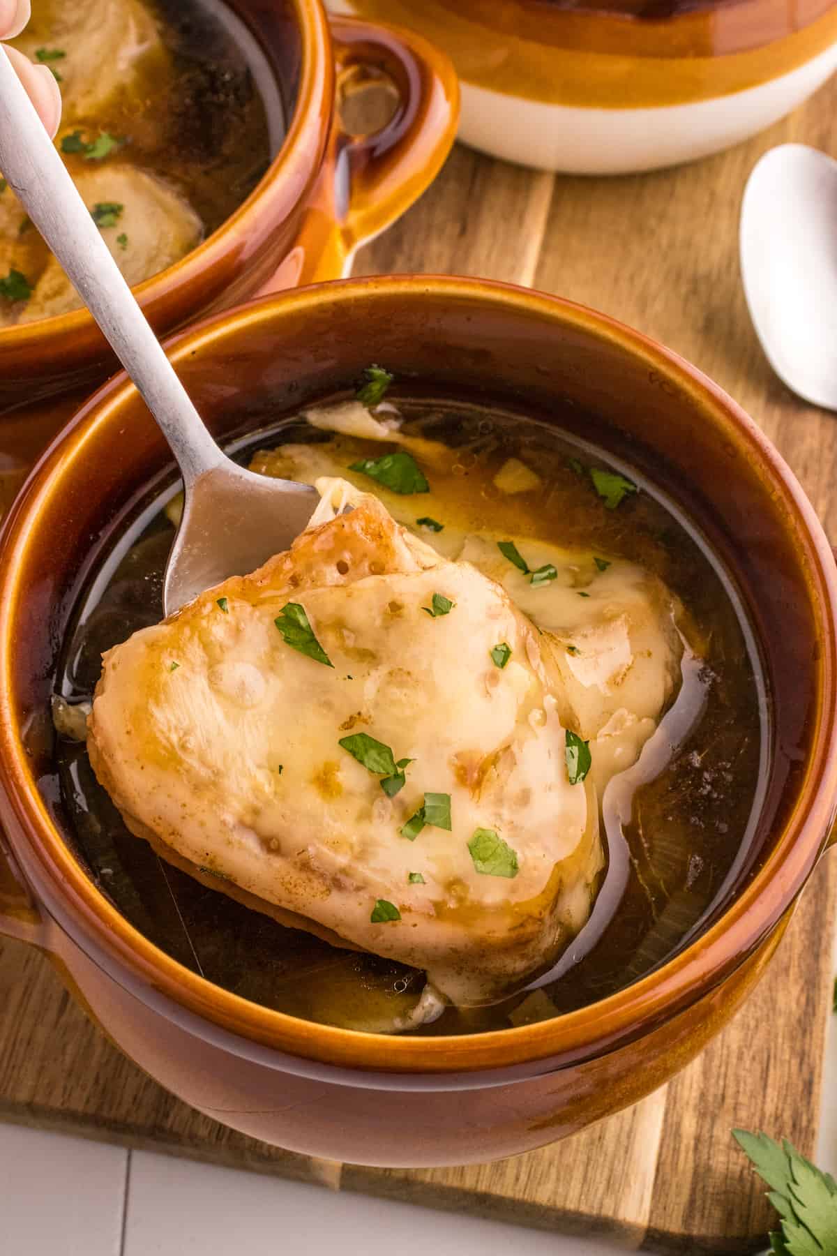 French onion soup in a bowl with a spoon.