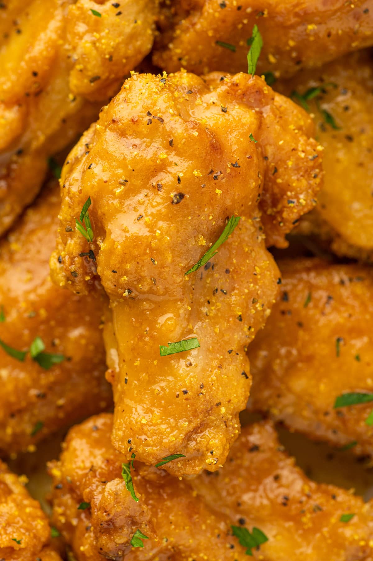 A close up of lemon pepper chicken wings on a plate.