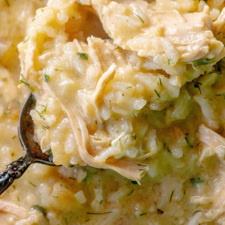 A spoonful of Greek chicken risotto in a casserole dish.