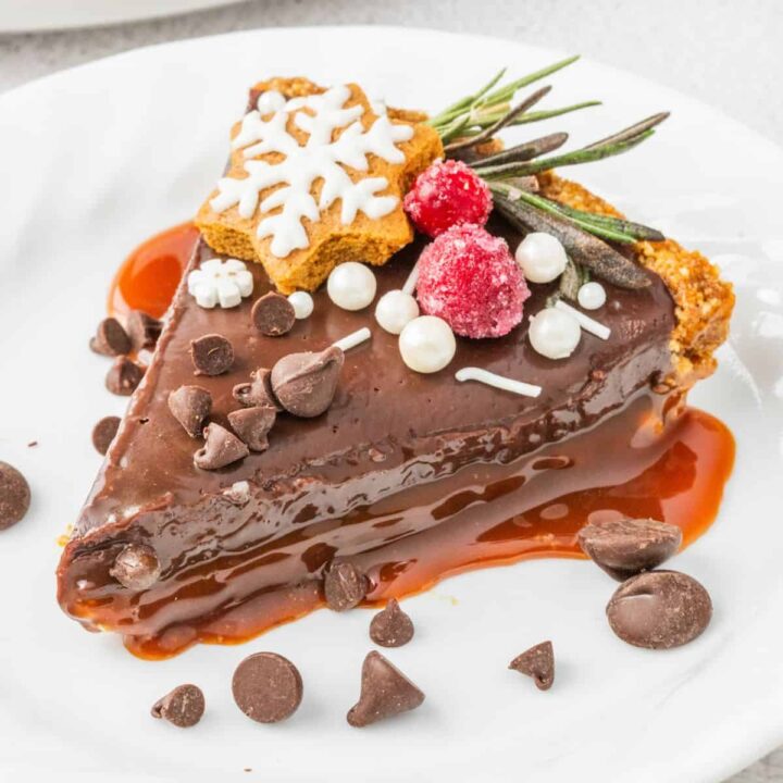 A delectable chocolate pie adorned with rich chocolate sauce on a plate.
