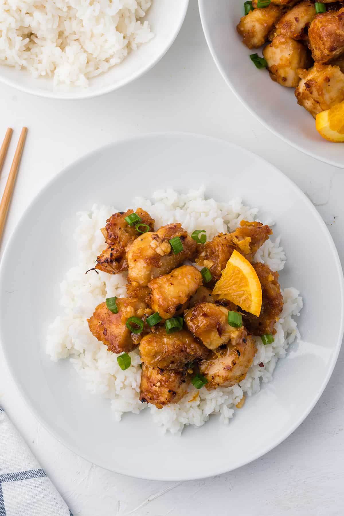 An appetizing plate of orange chicken with rice, prepared using an air fryer.