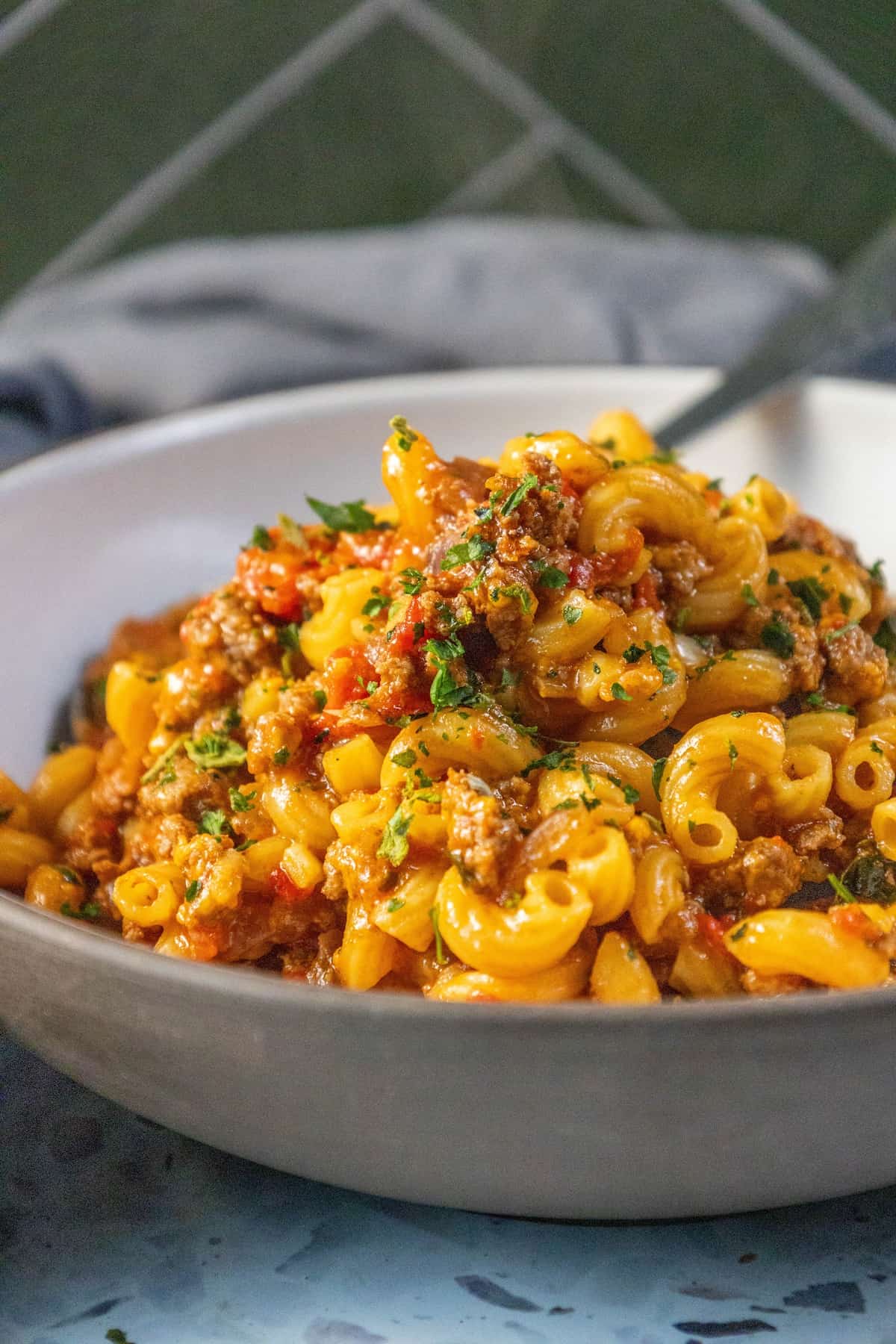 A flavorful American recipe featuring a hearty bowl of Goulash, a delicious combination of pasta, meat, and sauce.