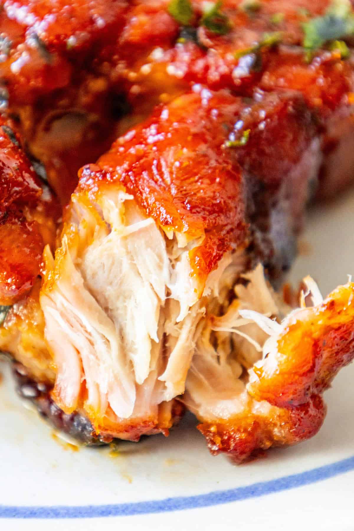 A close up of a boneless chicken on a plate.