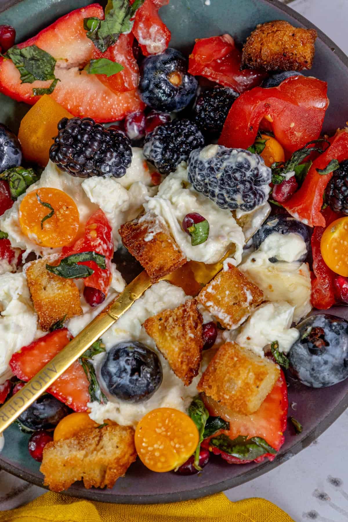 A bowl of fruit salad with berries.