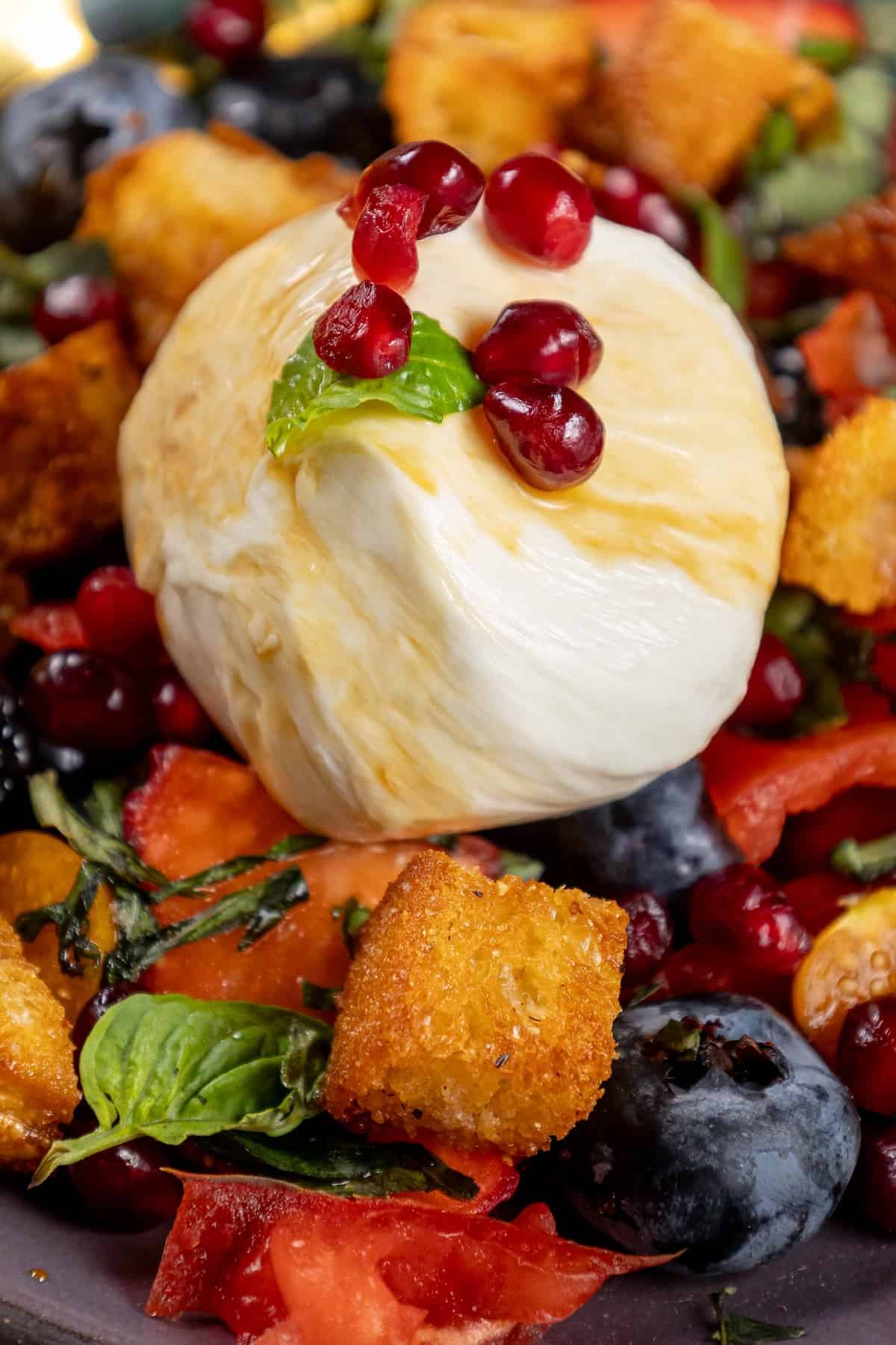 A salad with berries and a pomegranate sorbet.