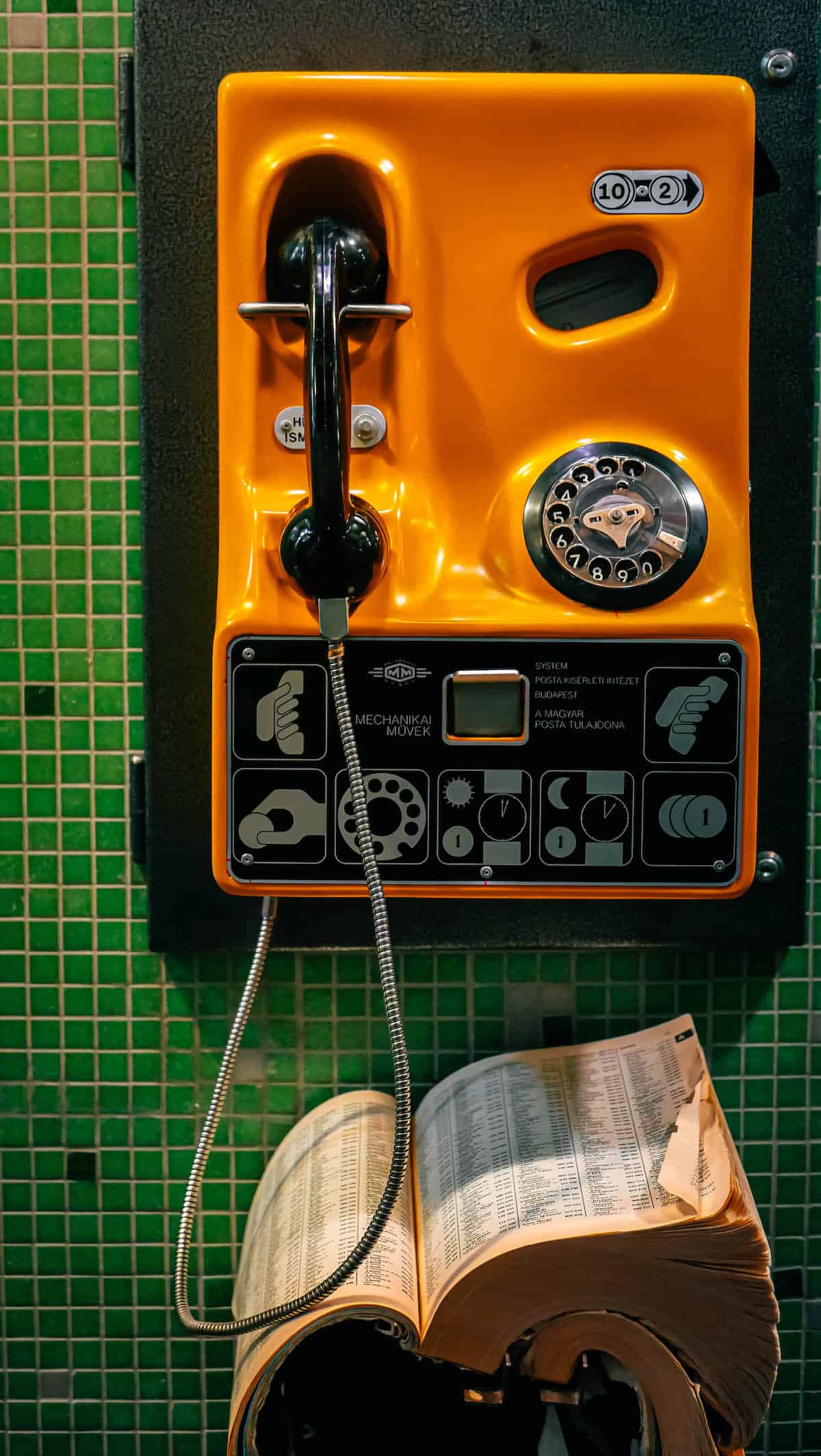 The Definitive Hungarian Goulash 15 A classic telephone resting beside an open book, symbolizing a cozy and reflective moment in Budapest.
