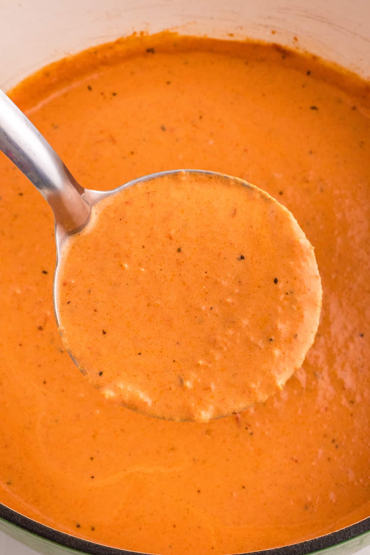 A creamy tomato soup in a pot.