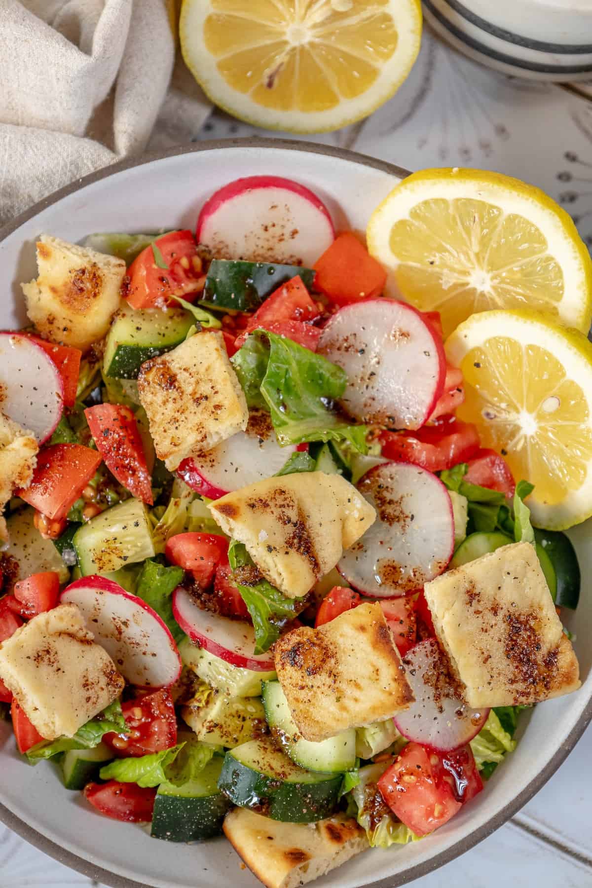 A Fattoush Salad with vegetables and a lemon.