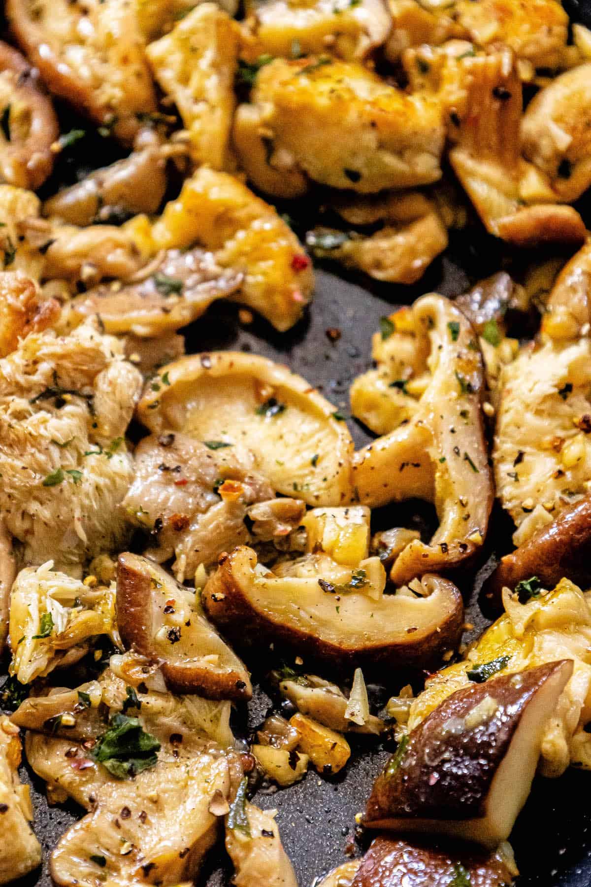 Chicken and mushrooms in a skillet, served with sauteed mushroom side dish.