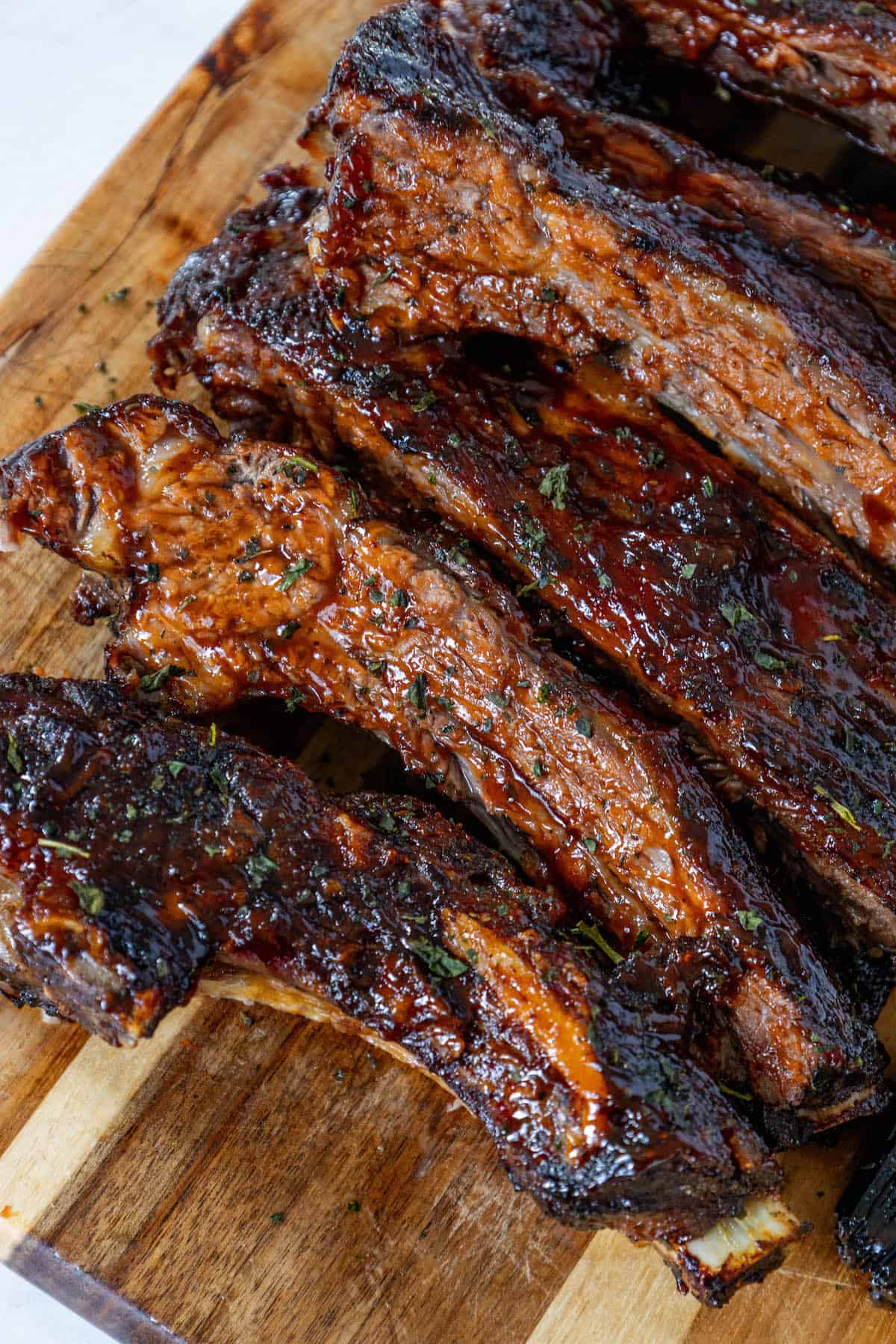 Oven Baked BBQ Ribs on a wooden cutting board.