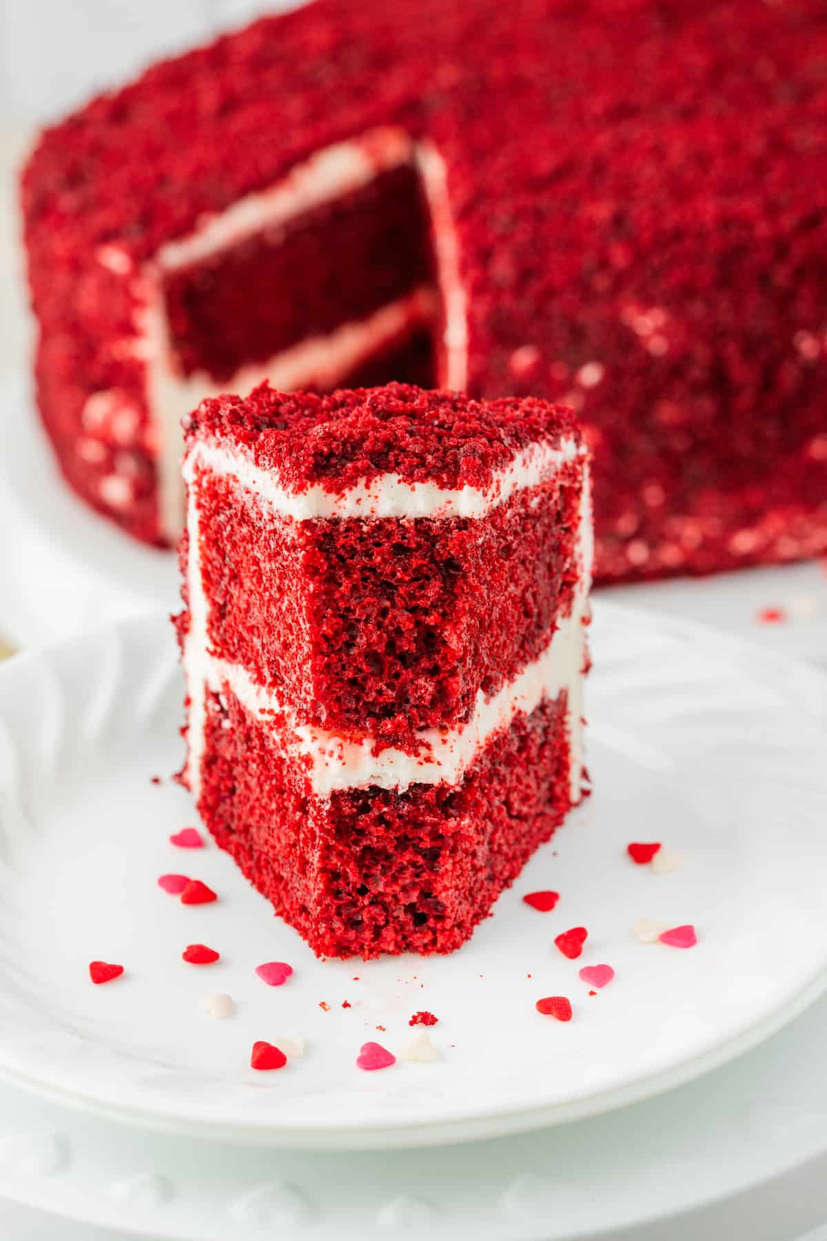 A delectable slice of red velvet cake placed elegantly on a plate.