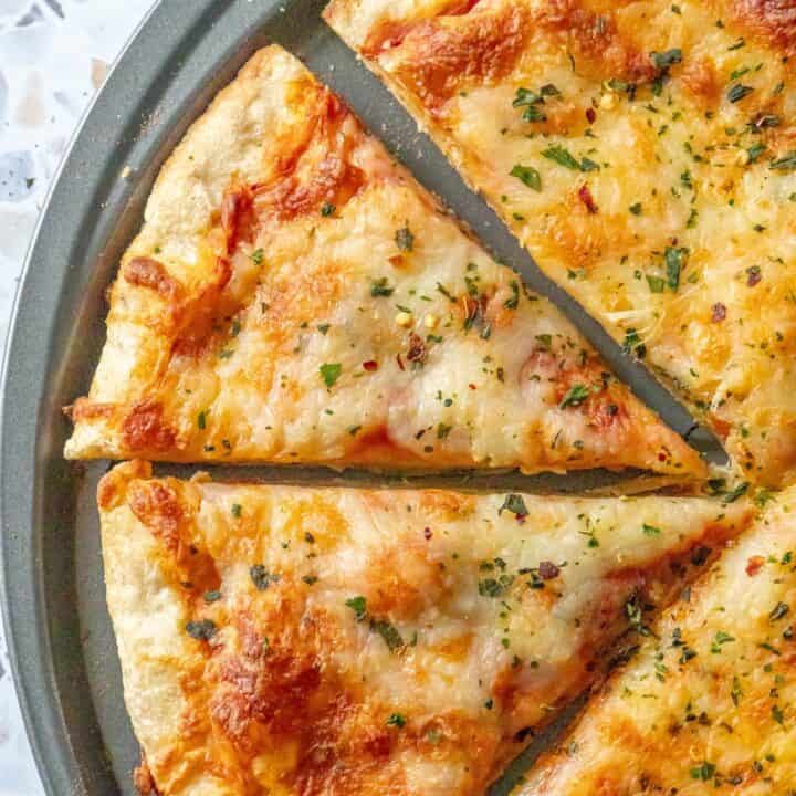 A slice of cheese pizza on a plate with the best pizza dough.