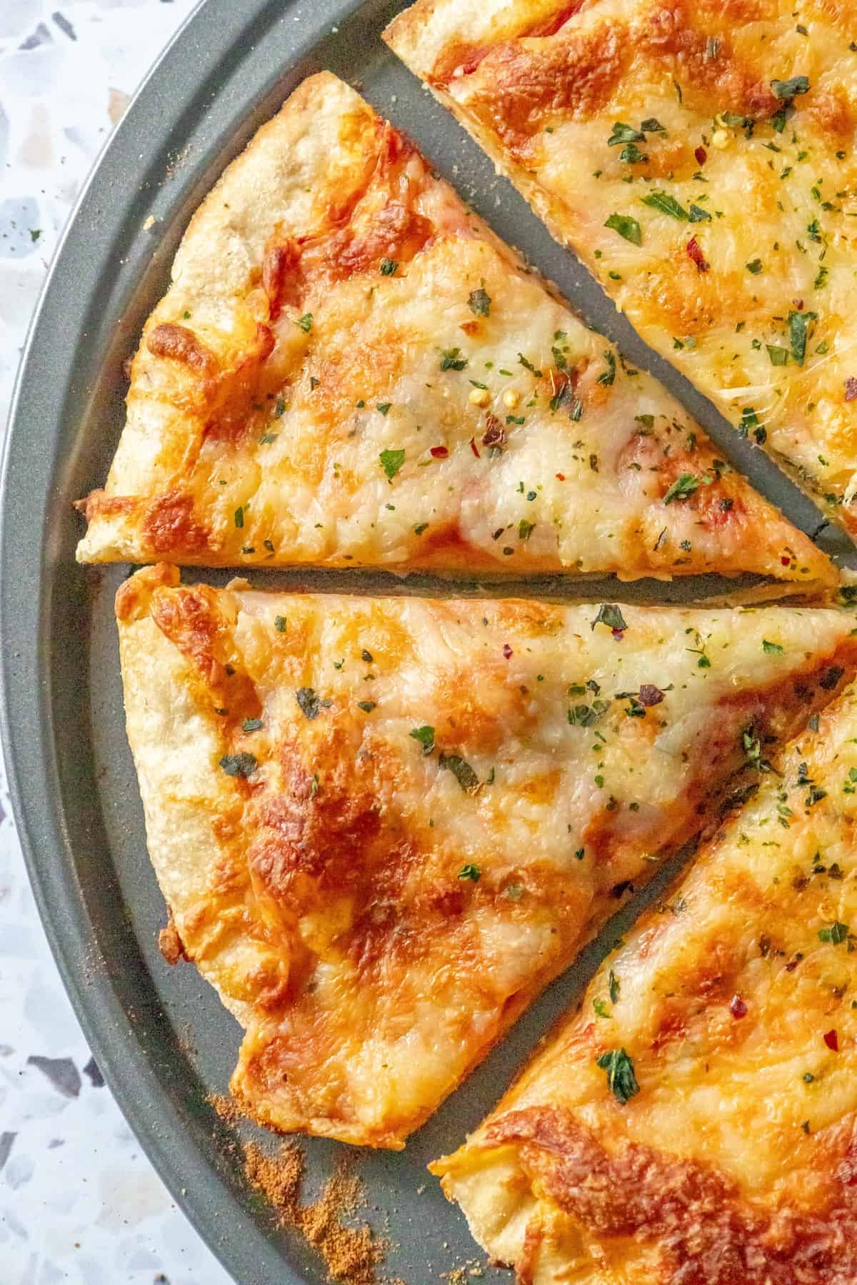 An easy homemade slice of cheese pizza on a plate.