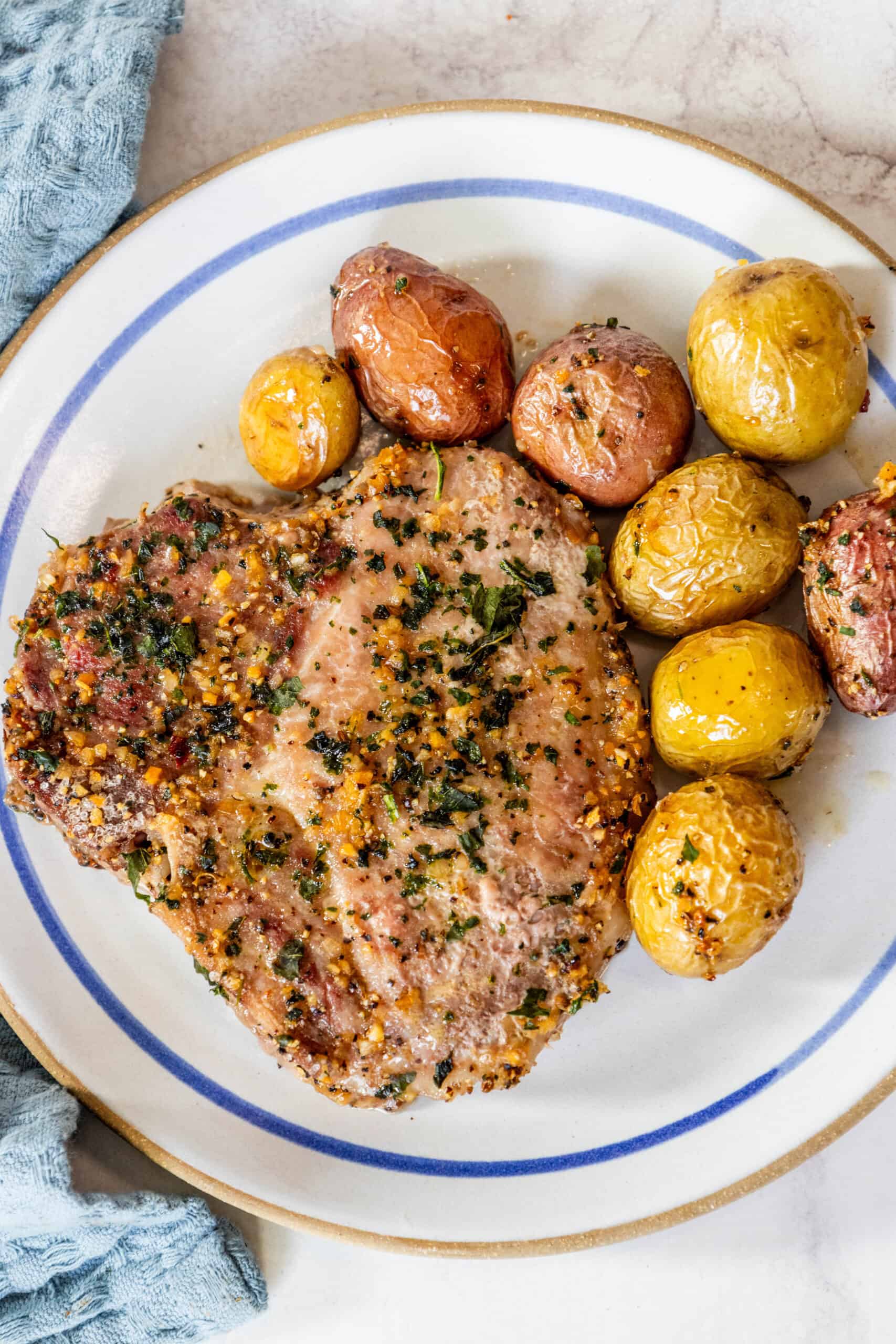 A plate of food with potatoes and pork chops.