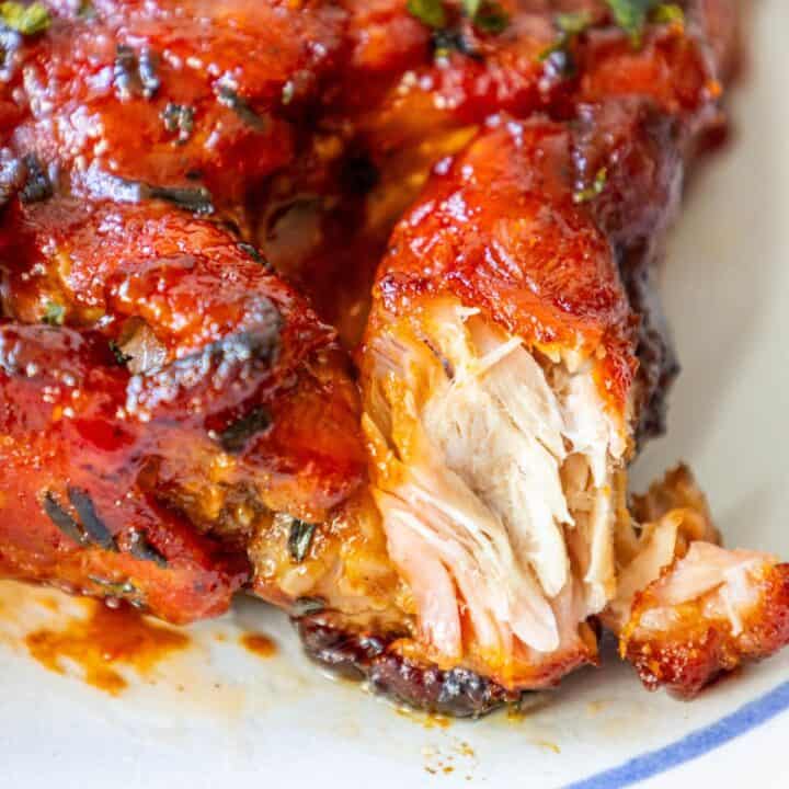 A close up of a baked piece of boneless chicken on a plate.