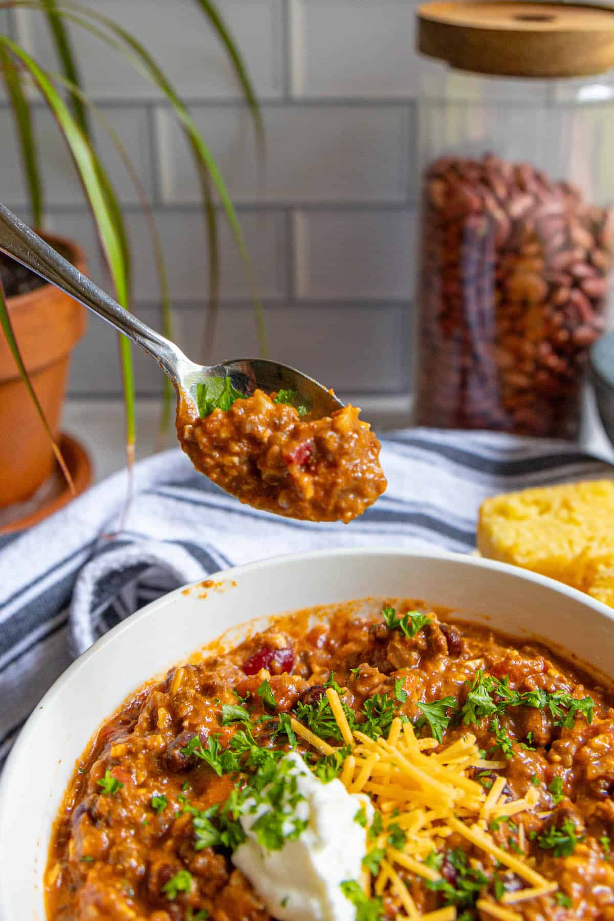 A bowl of chili with a spoon in it.