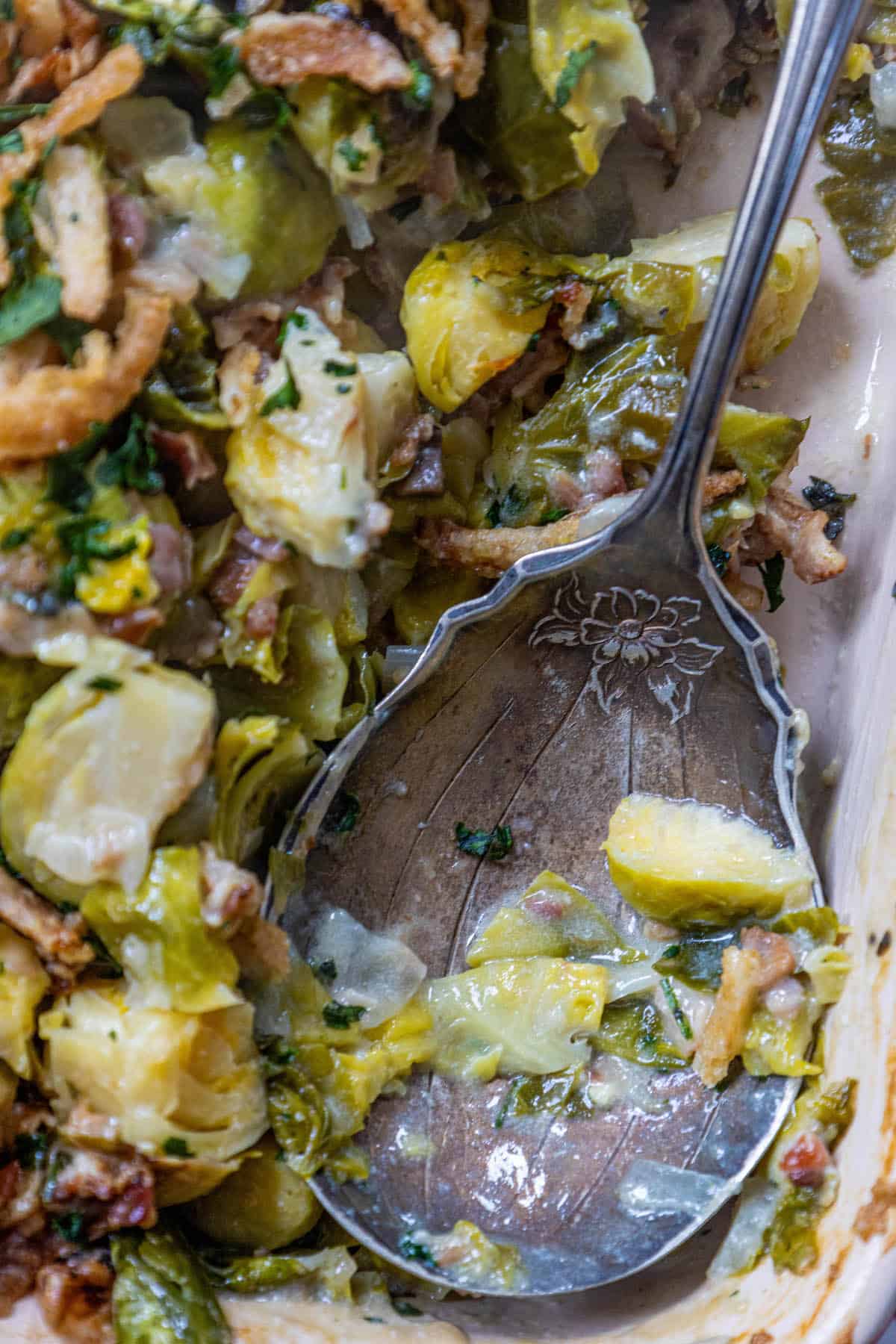 Creamy Brussels sprouts with bacon in a casserole dish.