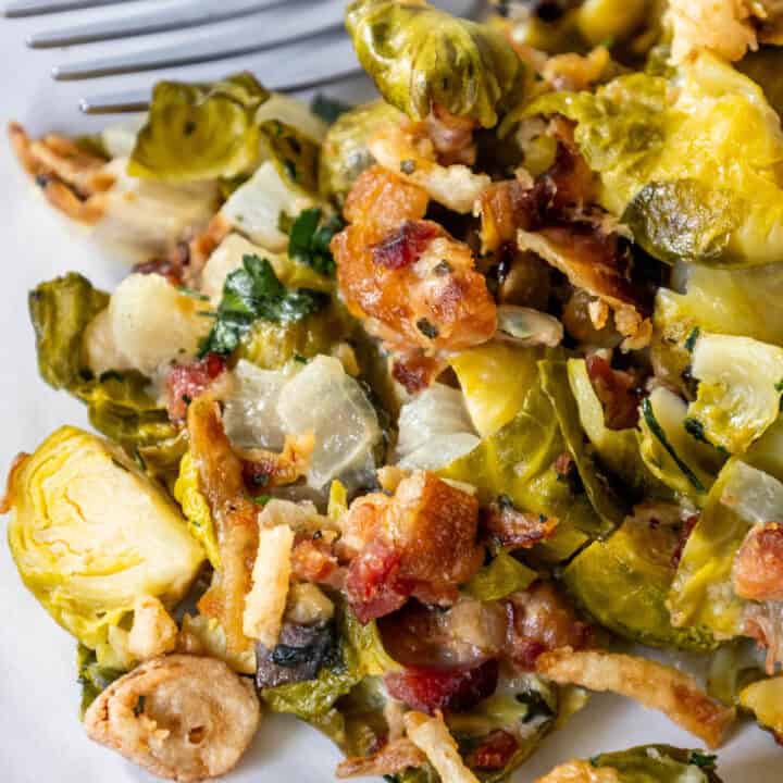 Creamy Brussels Sprouts with Bacon, served with a fork.