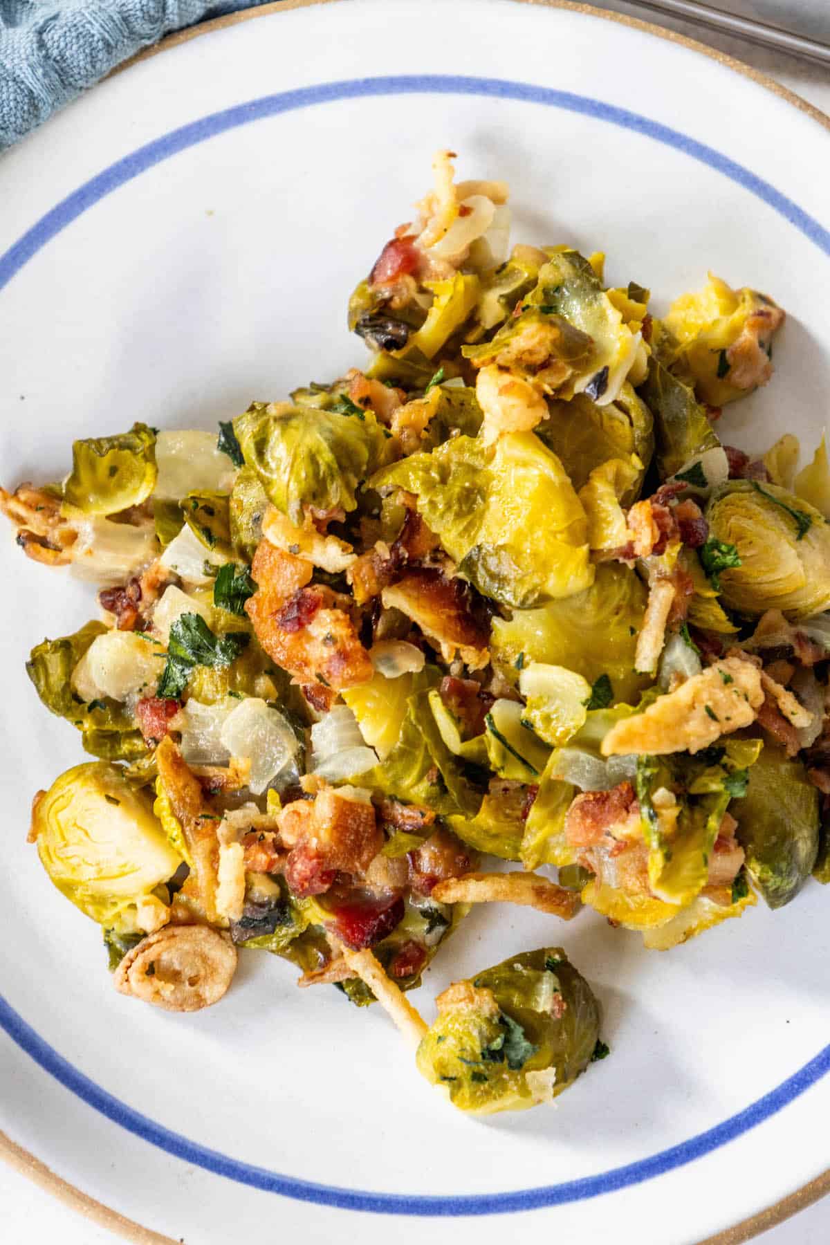 Creamy Brussels sprouts and bacon on a plate.