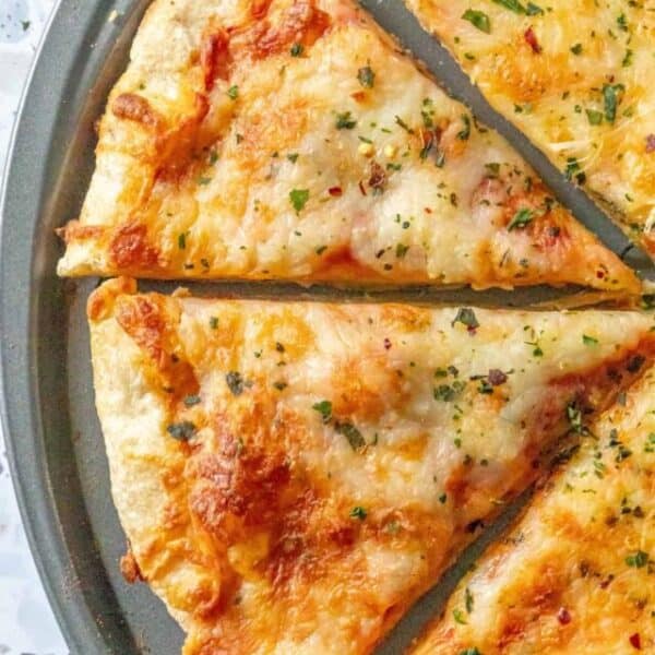 Slices of cheese pizza on a pan.