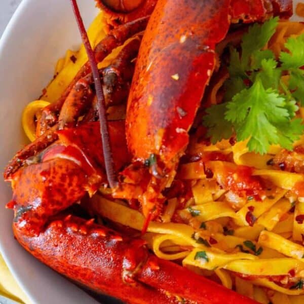 Lobster pasta in a white bowl.