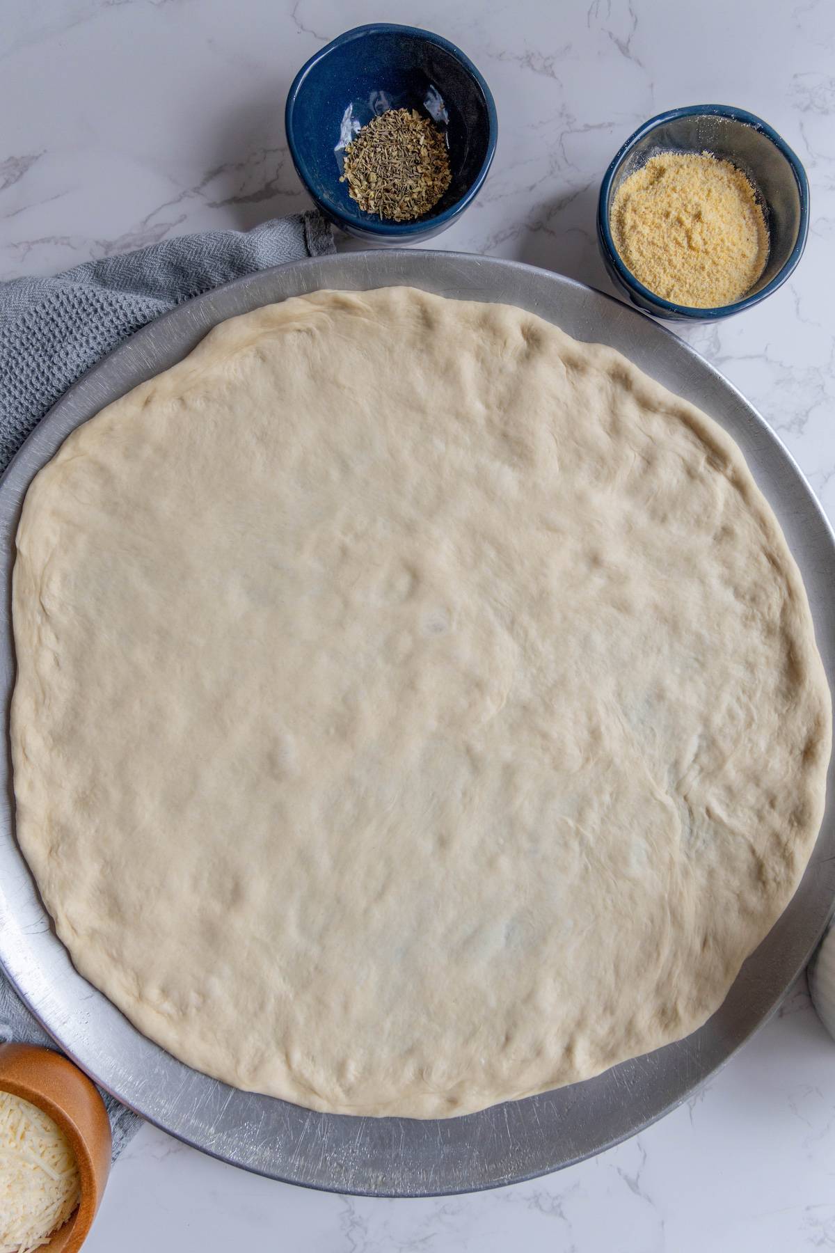 Easy homemade pizza dough on a marble countertop.