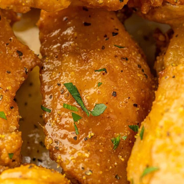 A mouthwatering close up of lemon pepper chicken wings.