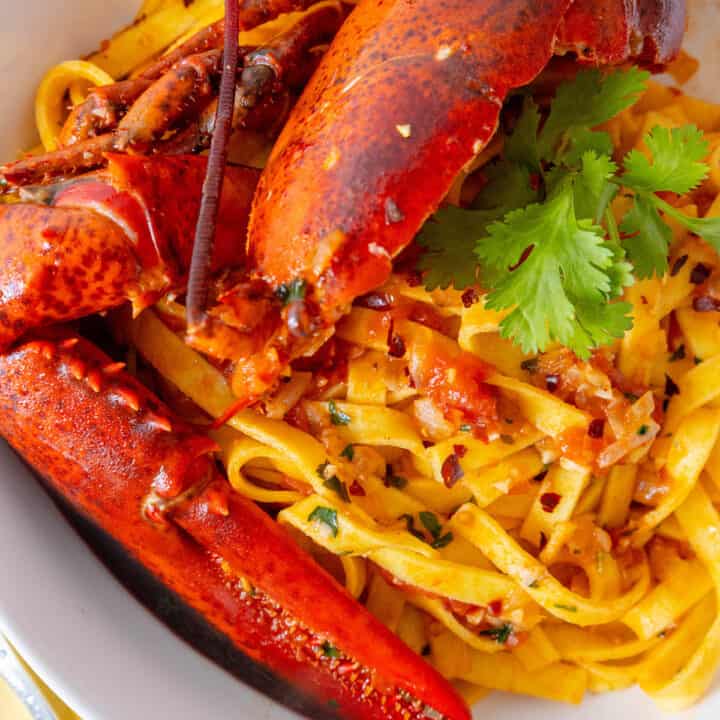 A tantalizing bowl of Lobster Pasta Busara, a Venetian delicacy that combines succulent lobster with delectable pasta.