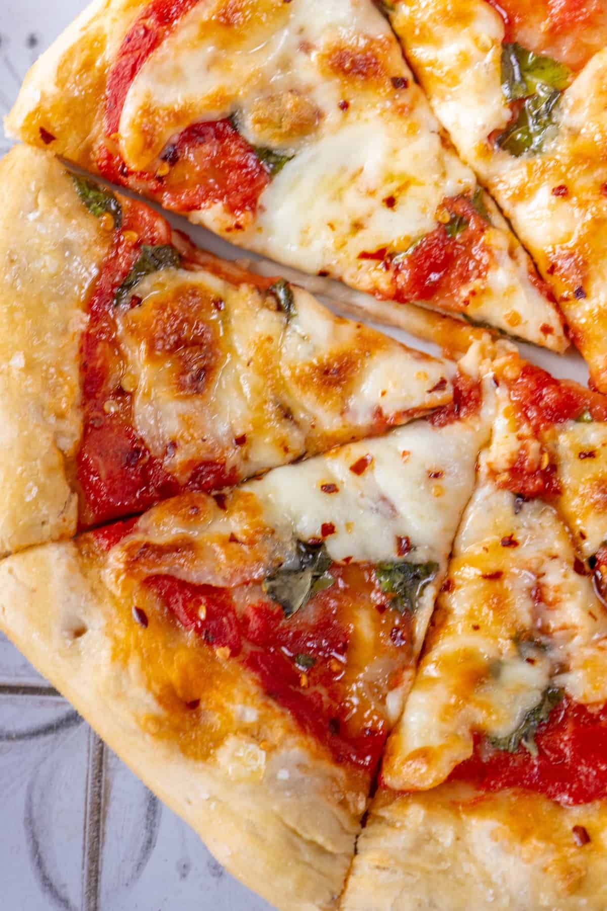 A Classic margherita pizza with a slice taken out of it.
