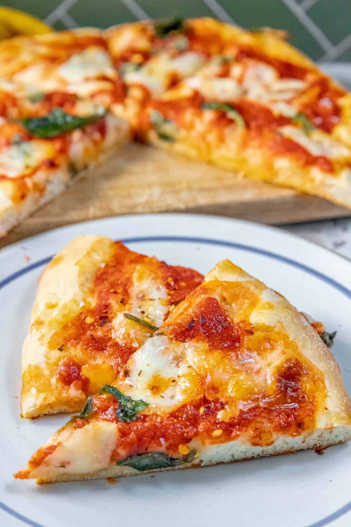 A classic margherita pizza slice on a plate.
