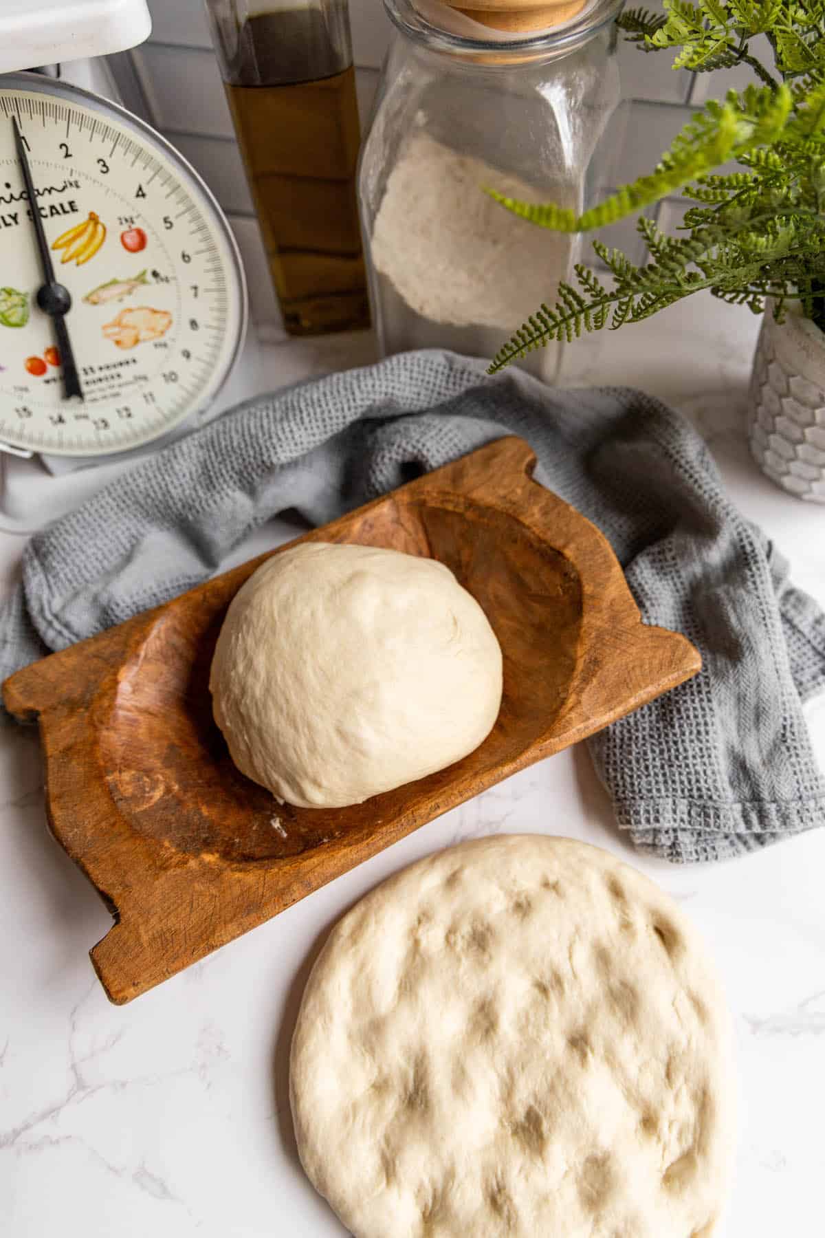 Homemade pizza dough on a wooden cutting board.