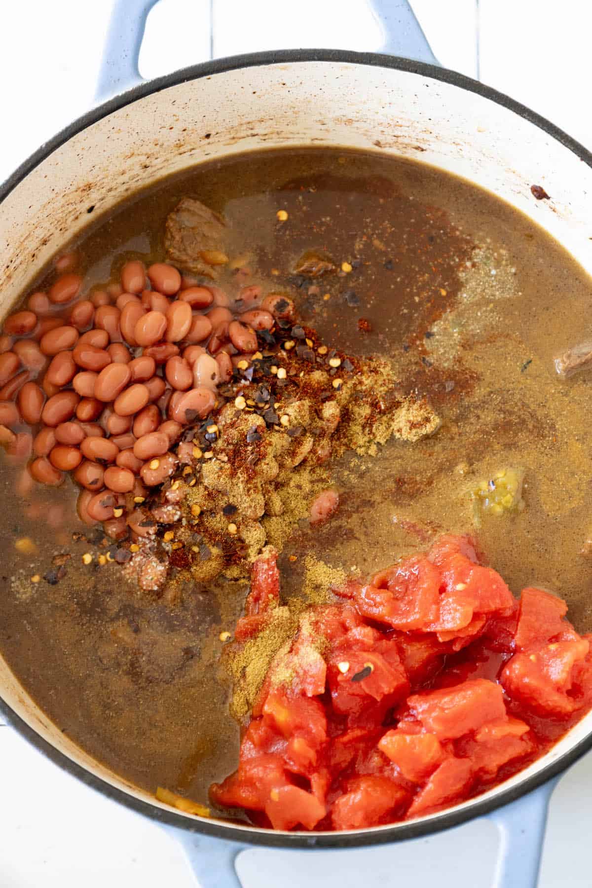 A spicy pot of beef stew with jalapeños, beans, and tomatoes.