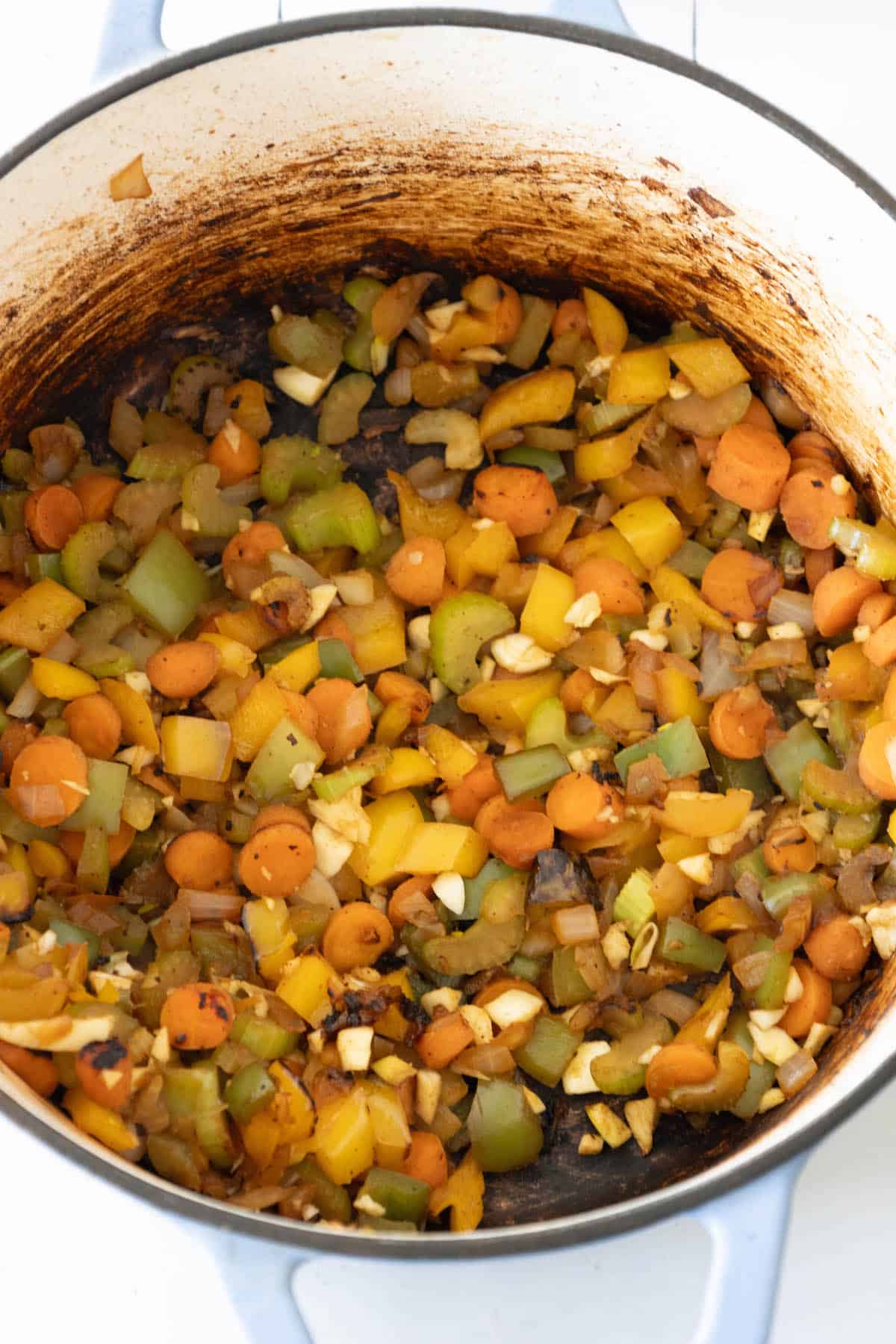 A pot of spicy beef stew, simmering on top of a stove.