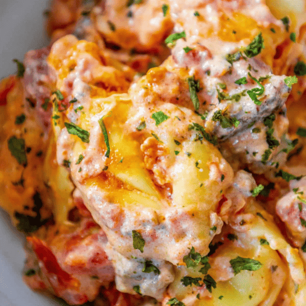 A bowl of Cheesy Tortellini food with sauce.