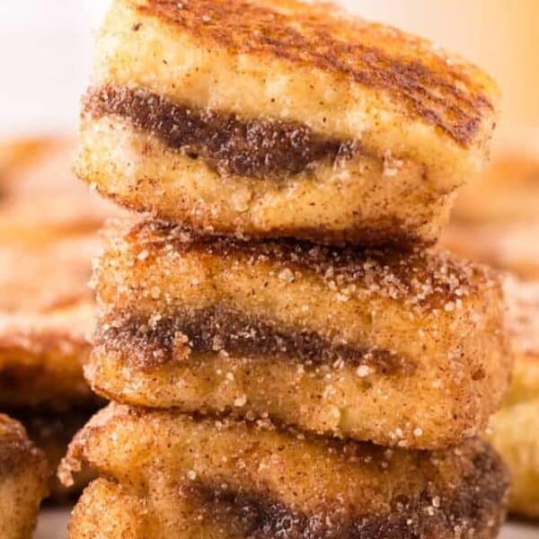 A stack of cinnamon raisin french toast stacked on top of each other.