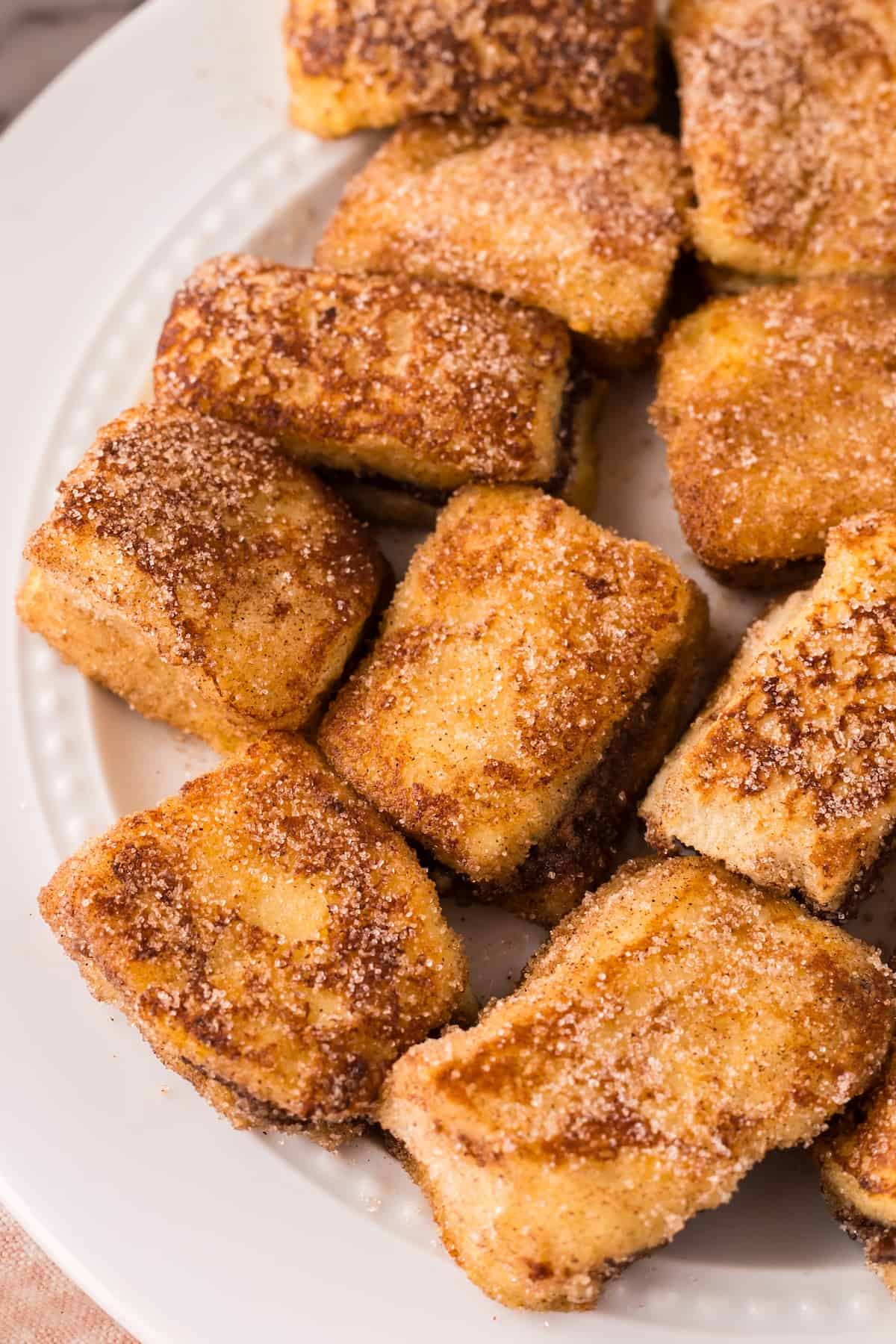 Stuffed French toast bites on a plate.
